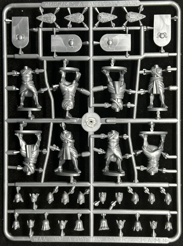 A silver unpainted miniature figurine sprue on a black background, containing multiple small character and accessory figures connected by plastic runner bars.