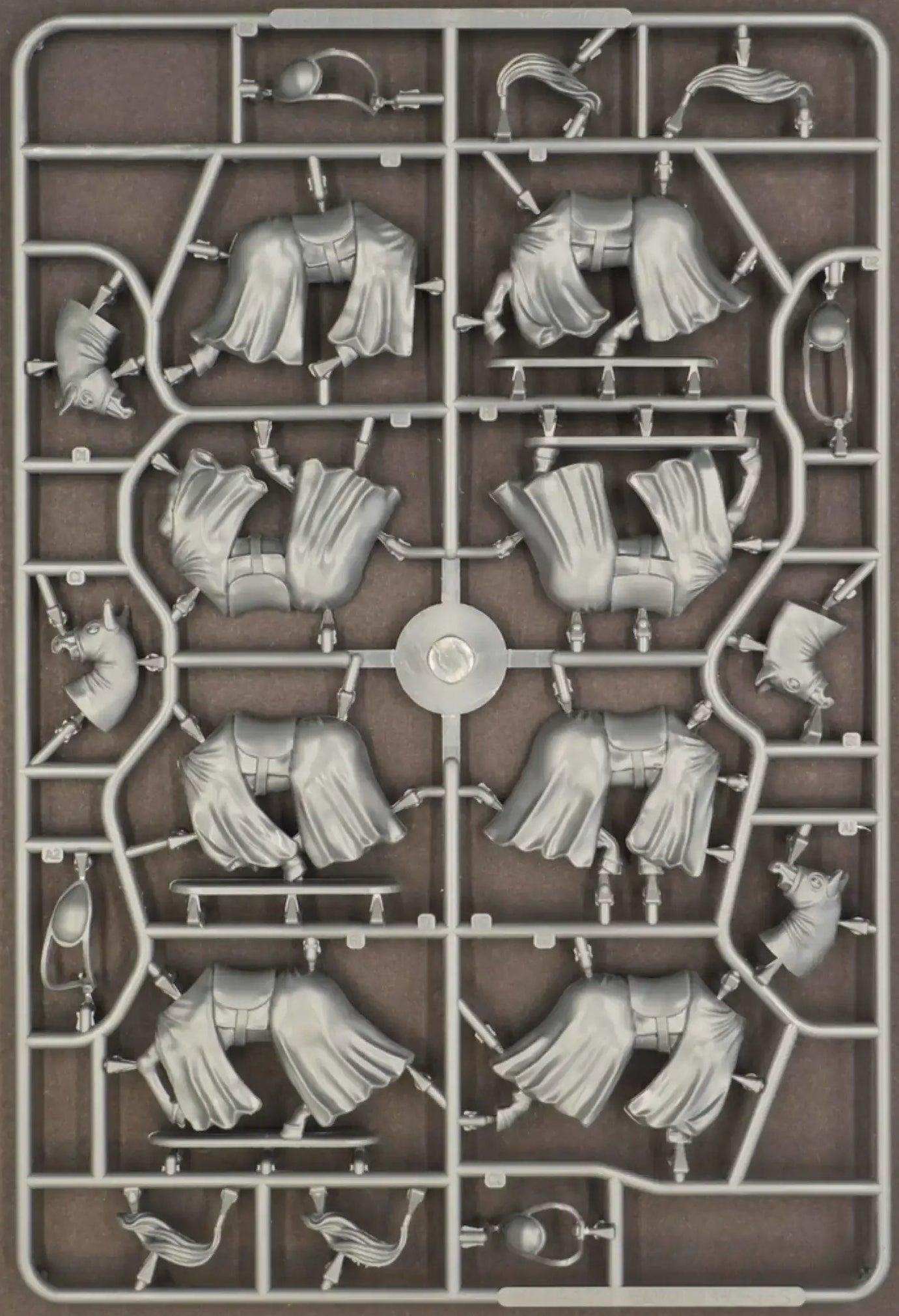 Sprue containing mounted knights' capes and armor components for 12th and 13th century war figures.